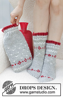 Christmas Sparkle Hot Bottle Cover / DROPS Extra 0-1582 - Gestrickter Wärmflaschenbezug / Bezug für Wärmflaschen in DROPS Snow. Die Arbeit wird von unten nach oben mit Streifen oder nordischem Muster gestrickt. Thema: Weihnachten.