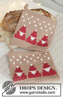Snowy Claus Potholders / DROPS Extra 0-1627 - Knitted pot holder in DROPS Paris. The piece is worked bottom up with Santas, bobbles and snowflakes. Theme: Christmas.