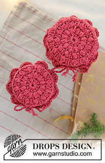 Holiday Jar Keeper / DROPS Extra 0-1629 - Crocheted jam jar cover in DROPS Belle. The piece is worked in the round, middle outwards, with puff-stitches and fan pattern. Theme: Christmas.