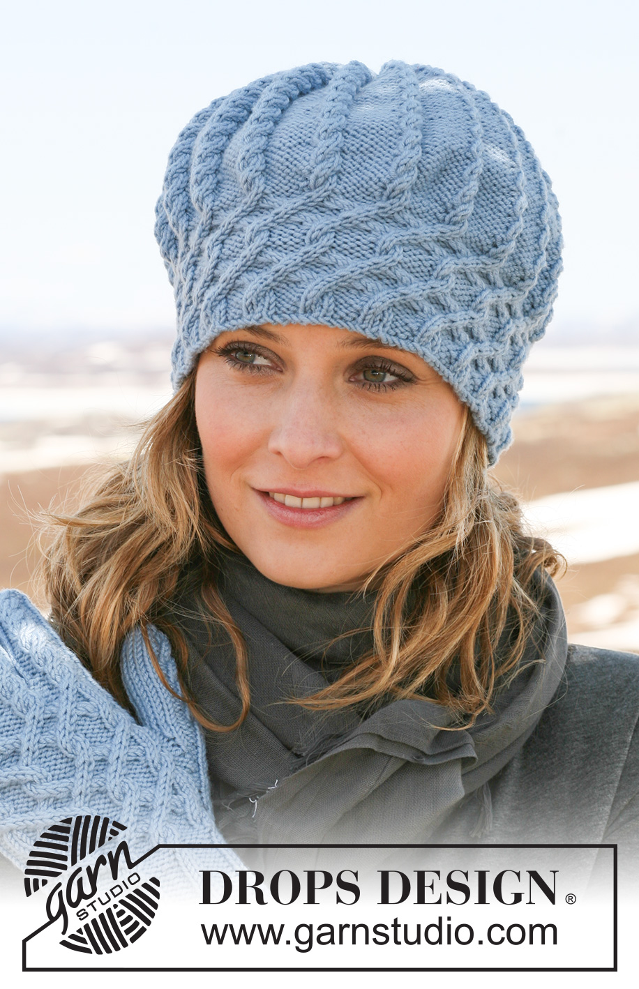 Blueberry Frost Hat / DROPS 115-44 - Knitted hat in  DROPS Merino Extra Fine with cables.