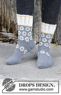 Winter Daisies / DROPS 193-7 - Knitted mittens in DROPS Nord. The piece is worked with Nordic pattern, Latvian cable and lace pattern. Size One-size.
Knitted socks in DROPS Nord. The piece is worked with Nordic pattern, Latvian cable and lace pattern. Sizes 35 – 43.