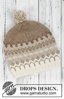 Talvik / DROPS 197-10 - Stickad tröja med runt ok i DROPS Alpaca. Arbetet är stickat uppifrån och ner med nordiskt mönster. Storlek S - XXXL. 
Stickad mössa med nordiskt mönster och garnboll i DROPS Alpaca.
