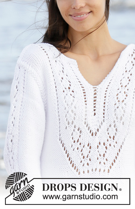 White Pearl / DROPS 199-2 - Knitted dress in DROPS Paris. The piece is worked with lace pattern, split in front of neck and ¾ length trumpet sleeves with lace pattern. Sizes S - XXXL.
