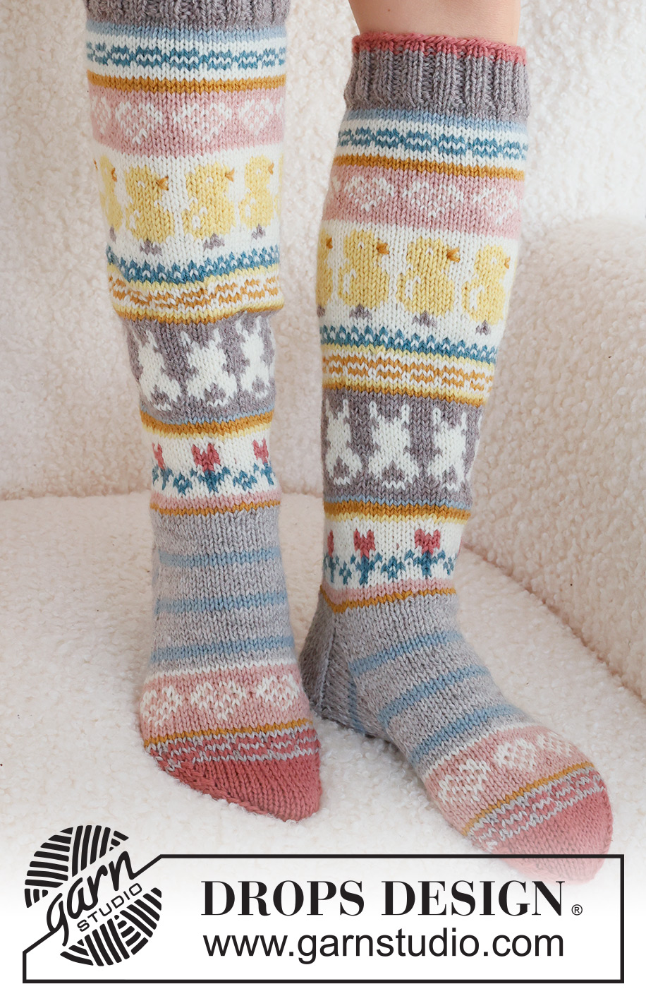 Easter Dance Socks / DROPS 229-35 - Knitted socks in DROPS Karisma. The piece is worked top down in stocking stitch, with multi-coloured pattern and heart, Easter chick, Easter bunny and flower. Sizes 35 - 43. Theme: Easter.
