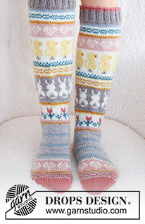 Easter Dance Socks / DROPS 229-35 - Knitted socks in DROPS Karisma. The piece is worked top down in stocking stitch, with multi-coloured pattern and heart, Easter chick, Easter bunny and flower. Sizes 35 - 43. Theme: Easter.