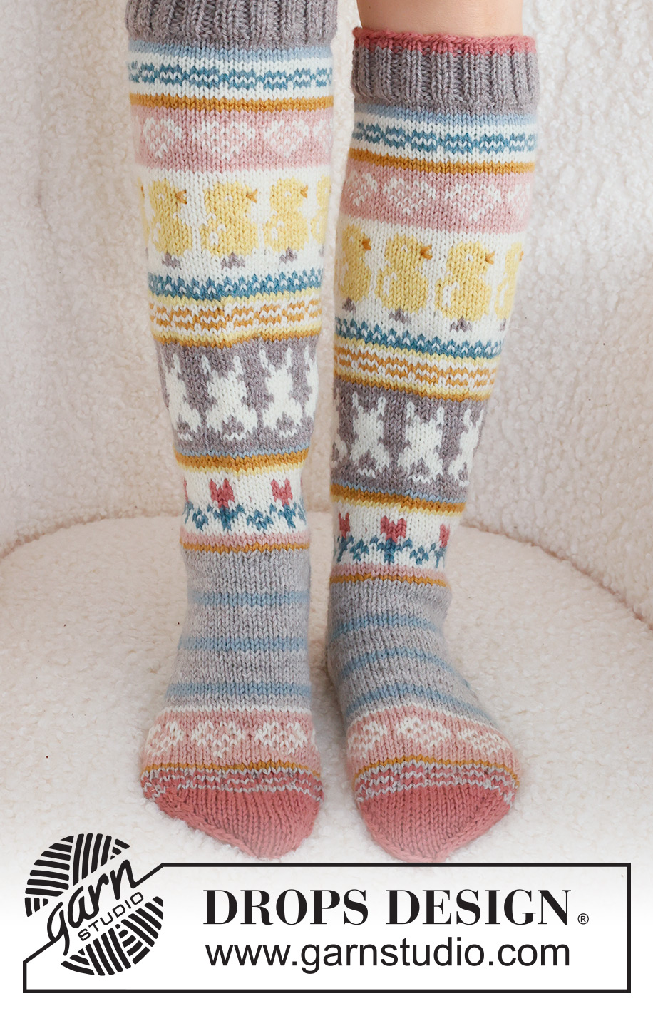 Easter Dance Socks / DROPS 229-35 - Knitted socks in DROPS Karisma. The piece is worked top down in stocking stitch, with multi-coloured pattern and heart, Easter chick, Easter bunny and flower. Sizes 35 - 43. Theme: Easter.