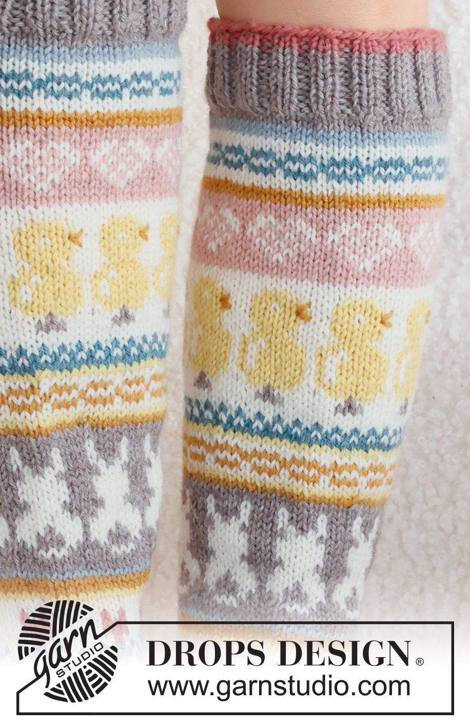 Easter Dance Socks / DROPS 229-35 - Knitted socks in DROPS Karisma. The piece is worked top down in stocking stitch, with multi-coloured pattern and heart, Easter chick, Easter bunny and flower. Sizes 35 - 43. Theme: Easter.