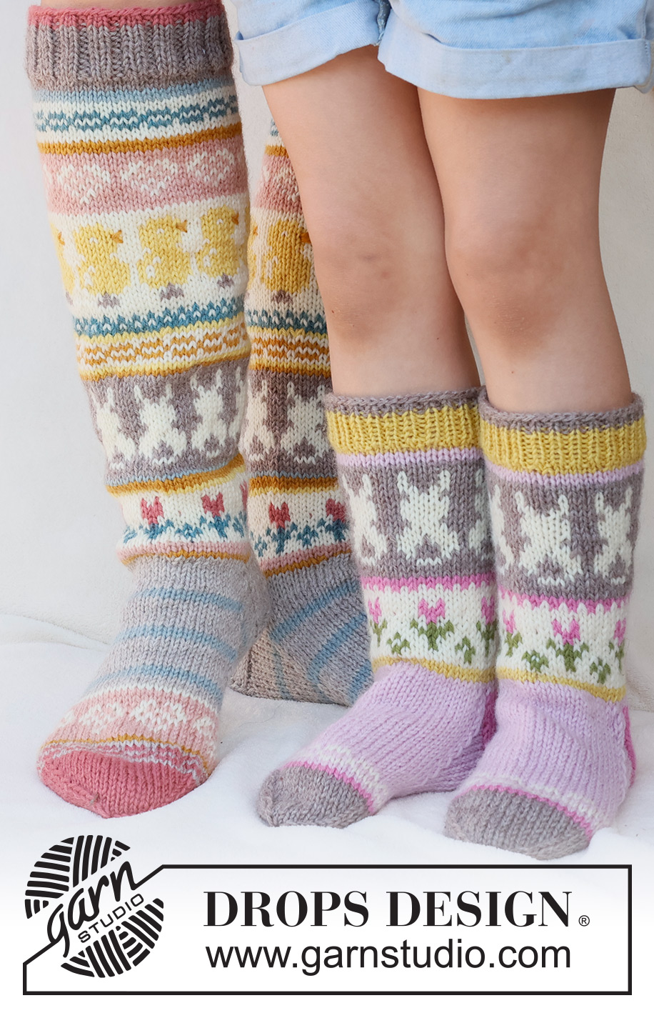 Easter Dance Socks / DROPS 229-35 - Knitted socks in DROPS Karisma. The piece is worked top down in stocking stitch, with multi-coloured pattern and heart, Easter chick, Easter bunny and flower. Sizes 35 - 43. Theme: Easter.