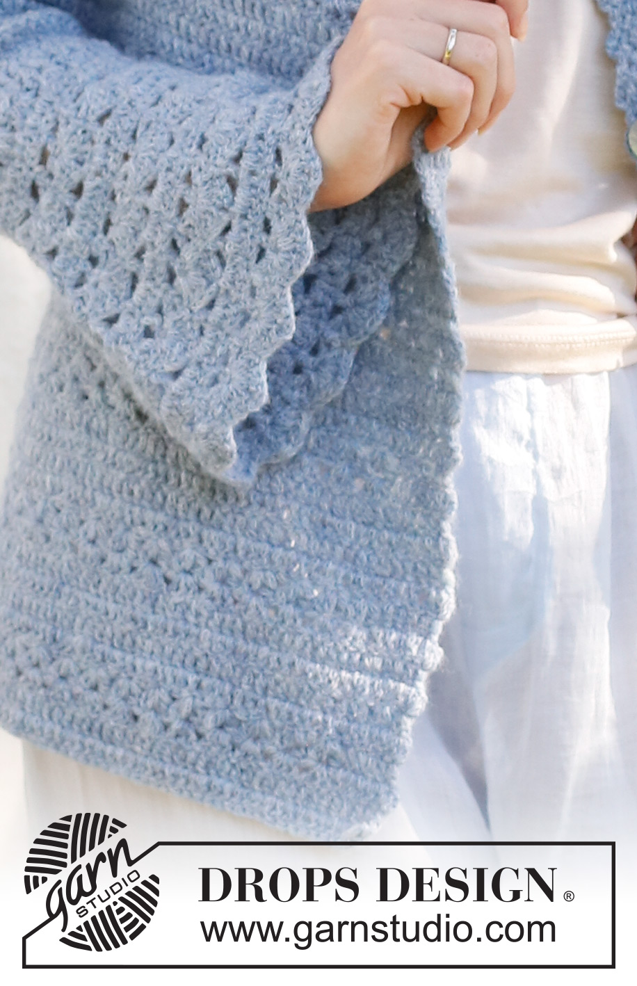 Spring Renaissance Cardigan / DROPS 230-38 - Crocheted jacket in DROPS Sky. The piece is worked top down with round yoke, lace and fan pattern and trumpet sleeves. Sizes S - XXXL.