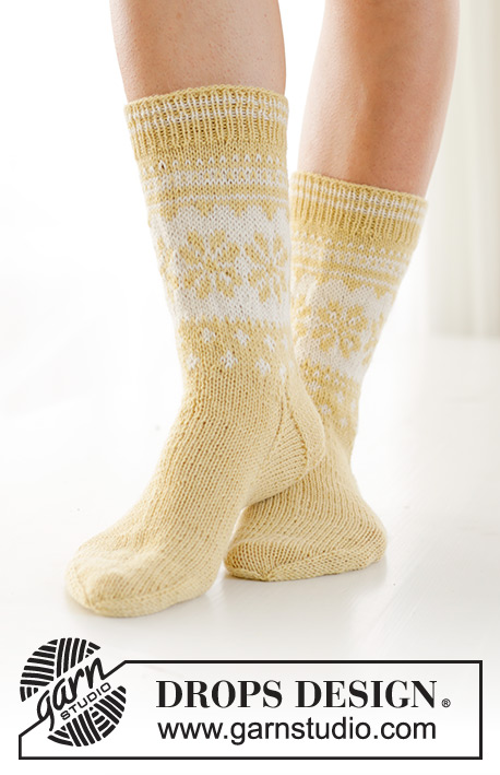Easter Promenade Socks / DROPS 247-21 - Knitted socks in DROPS Nord. The piece is worked top down, with Nordic pattern and heel flap. Sizes 35 – 43. Theme: Easter.