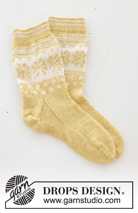 Easter Promenade Socks / DROPS 247-21 - Knitted socks in DROPS Nord. The piece is worked top down, with Nordic pattern and heel flap. Sizes 35 – 43. Theme: Easter.