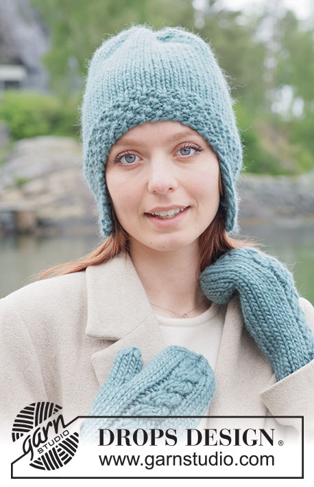 Tidebound Twist Hat / DROPS 261-44 - Gebreide muts met oorflappen in DROPS Snow. Het werk wordt van onder naar boven gebreid met dubbele gerstekorrel en tricotsteek.