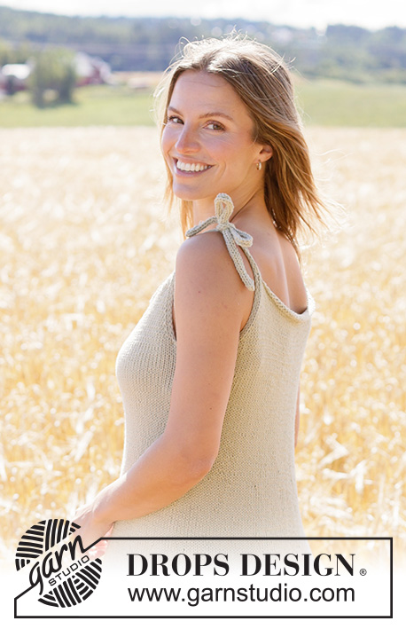 Breezy Oats Dress / DROPS 266-38 - Prjónaður kjóll úr DROPS Paris. Stykkið er prjónað ofan frá og niður með böndum á öxlum, i-cord og pífu. Stærð XS - XXXL.