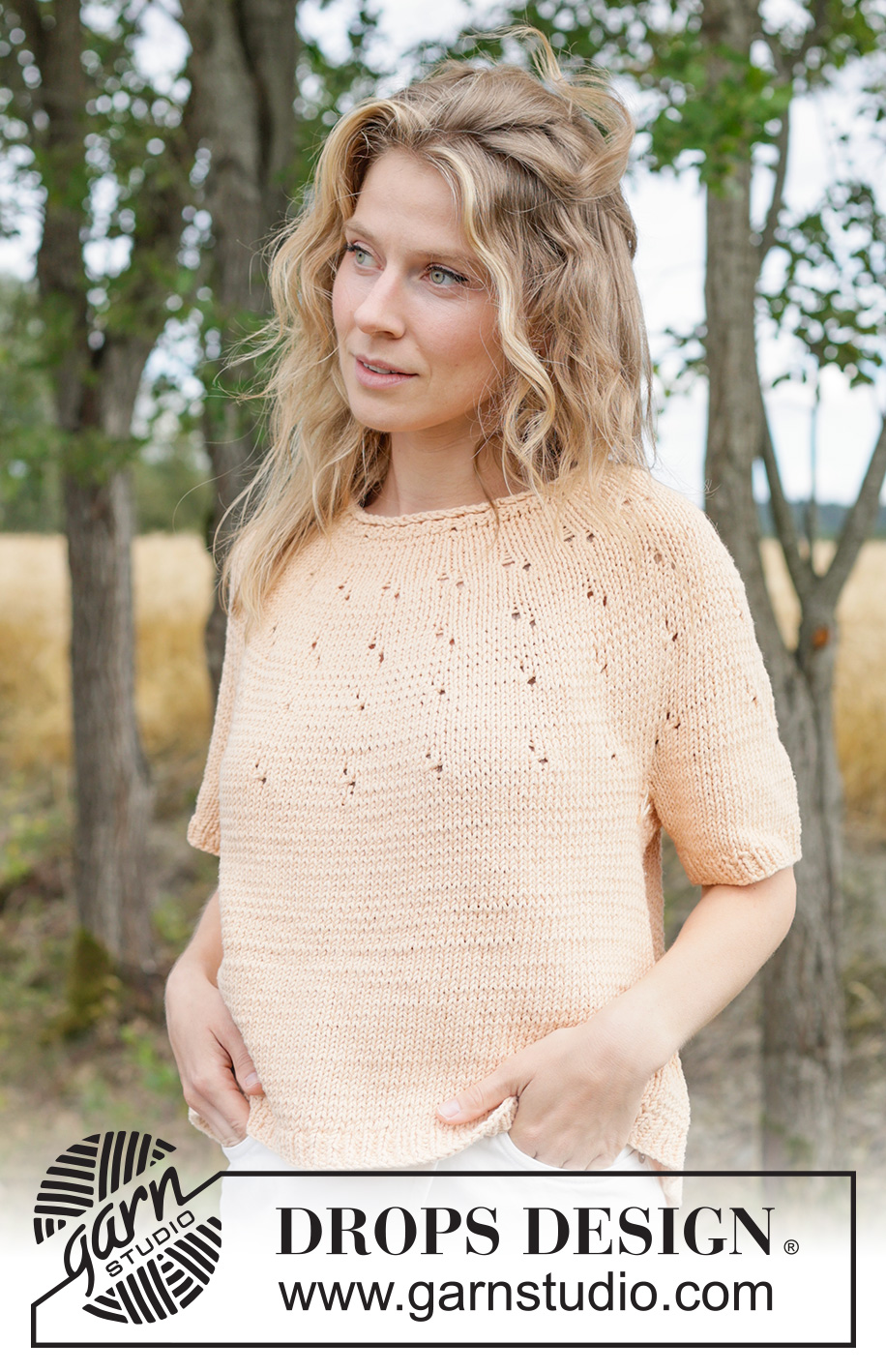 Peach Whisper Top / DROPS 268-22 - Jersey a punto con manga corta en DROPS Paris. La labor se trabaja de arriba abajo con borde enrollado, canesú redondo y patrón de calados en el canesú. Talla XS – XXXL