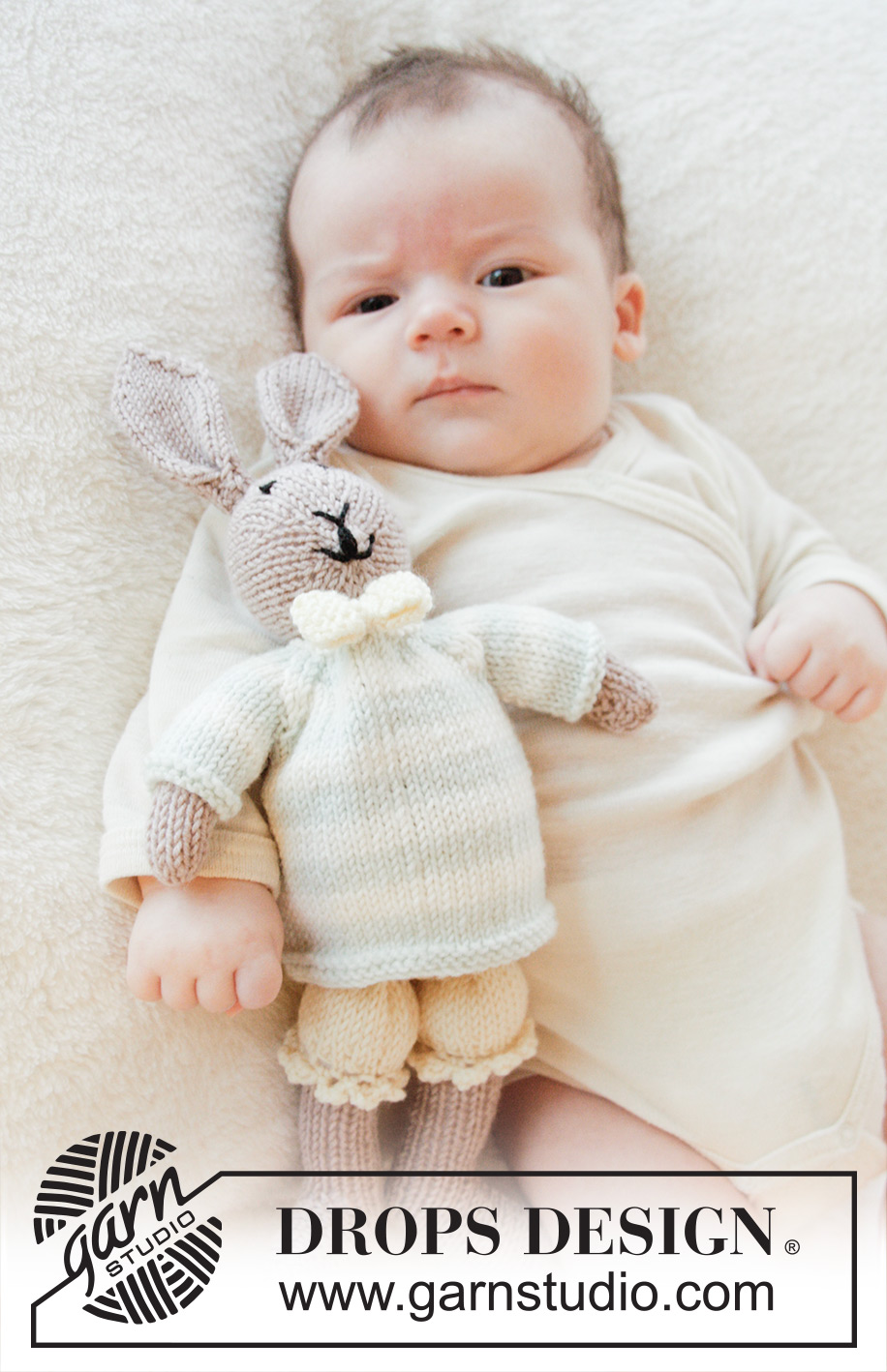 Mr. Bunny / DROPS Baby 25-8 - Knitted bunny toy with pants, jumper and bow in DROPS BabyMerino