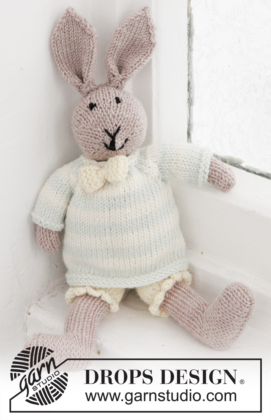 Mr. Bunny / DROPS Baby 25-8 - Knitted bunny toy with pants, jumper and bow in DROPS BabyMerino