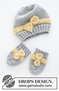 Little Miss Ribbons / DROPS Baby 31-11 - Conjunto de punto con gorro y manoplas para bebé en DROPS BabyMerino. El conjunto está tejido con punto de arroz y lazo. Tallas conjunto completo: 1 – 9 meses. Tallas gorro: prematuro – 4 años.