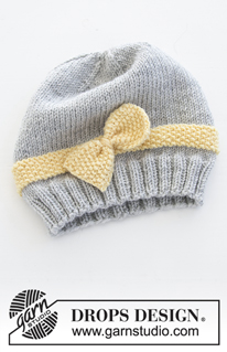 Little Miss Ribbons / DROPS Baby 31-11 - Conjunto de punto con gorro y manoplas para bebé en DROPS BabyMerino. El conjunto está tejido con punto de arroz y lazo. Tallas conjunto completo: 1 – 9 meses. Tallas gorro: prematuro – 4 años.