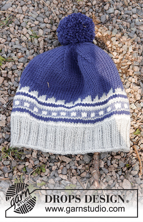 Little Adventure Set / DROPS Children 27-33 - Set of knitted hat with multi-coloured pattern and pompom, plus neck warmer with twist and English rib in DROPS Merino Extra Fine. Size children 3 - 12 years