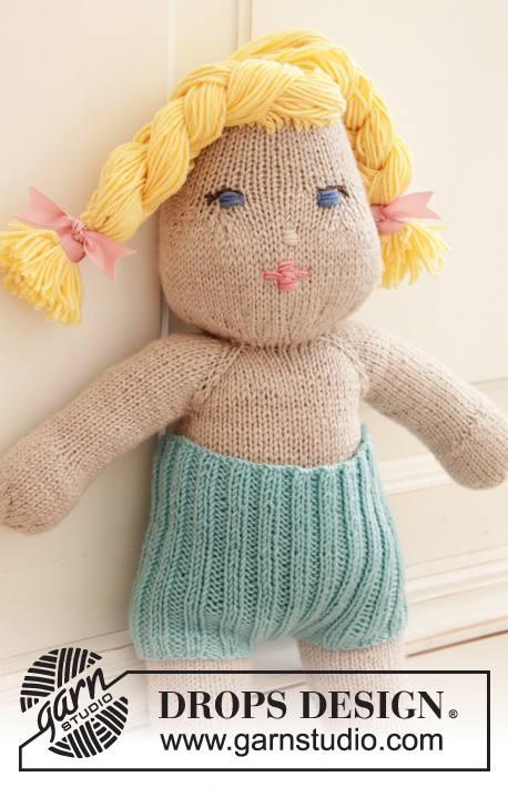 Cora / DROPS Children 35-12 - Knitted doll with short pants and tube socks. The doll is worked top down in stocking stitch with 2 strands DROPS BabyMerino or 1 strand  DROPS Big Merino, and DROPS Cotton Merino. Short pants and tube socks are worked in rib with 1 strand DROPS BabyMerino.