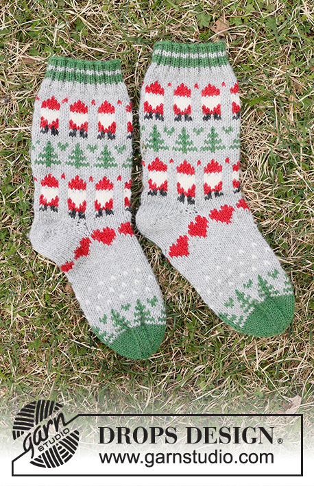 Christmas Time Socks / DROPS Children 44-20 - Knitted socks for children in DROPS Karisma. The piece is worked top down with coloured pattern Santa, Christmas tree and heart. Sizes 24 – 43. Theme: Christmas.