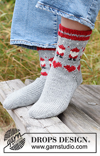 Santa Time Socks / DROPS Children 44-22 - Knitted socks for children in DROPS Karisma. The piece is worked top down with coloured Santa and heart-pattern. Sizes 24 – 43. Theme: Christmas.
